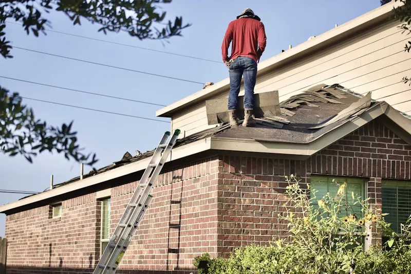 Professional roofer working on a residential roof in Ebensburg